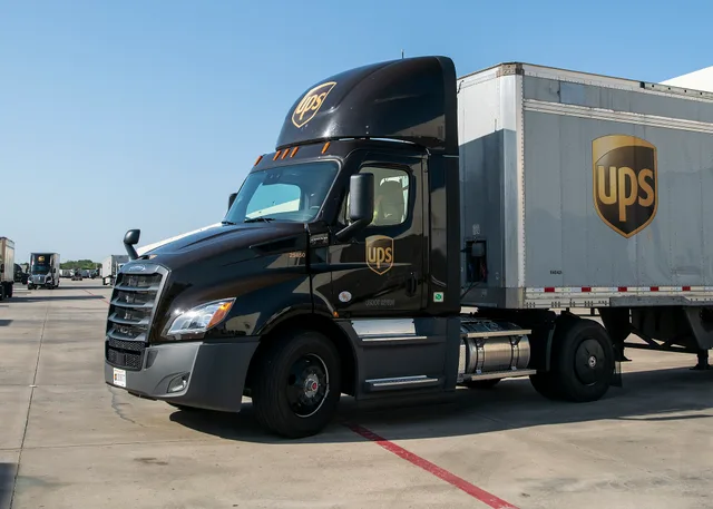 UPS feeder driver Birrill Taylor backs his assighed new diesel tractor to an offload dock at the UPS Lone Star distribution center (hub), in Arlington, TX, on August 14, 2020. Today, he picked up a trailer full of these boxes from Pro Pac Quality Packaging who pack and label the boxes for PepsiCo, w. Why movers charge per hour differently across US cities