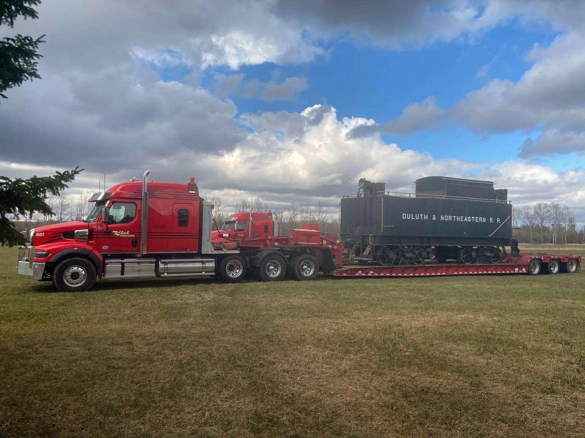 Semi-truck moving Duluth & Northeastern Rail Road car Carlton County Fair Barnum, Minnesota, USA. Four expansion moves for a moving company and what each one breaks first