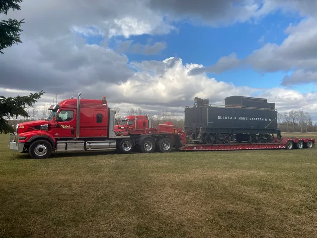 Semi-truck moving Duluth & Northeastern Rail Road car Carlton County Fair Barnum, Minnesota, USA. Four expansion moves for a moving company and what each one breaks first
