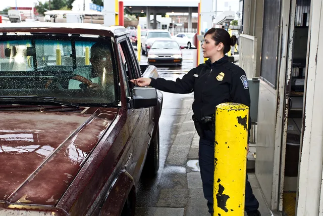 An OFO Officer checks the paperwork of an individual coming into the US. Photographer: Josh Denmark. Seattle to Canada moves: the CBSA customs paperwork